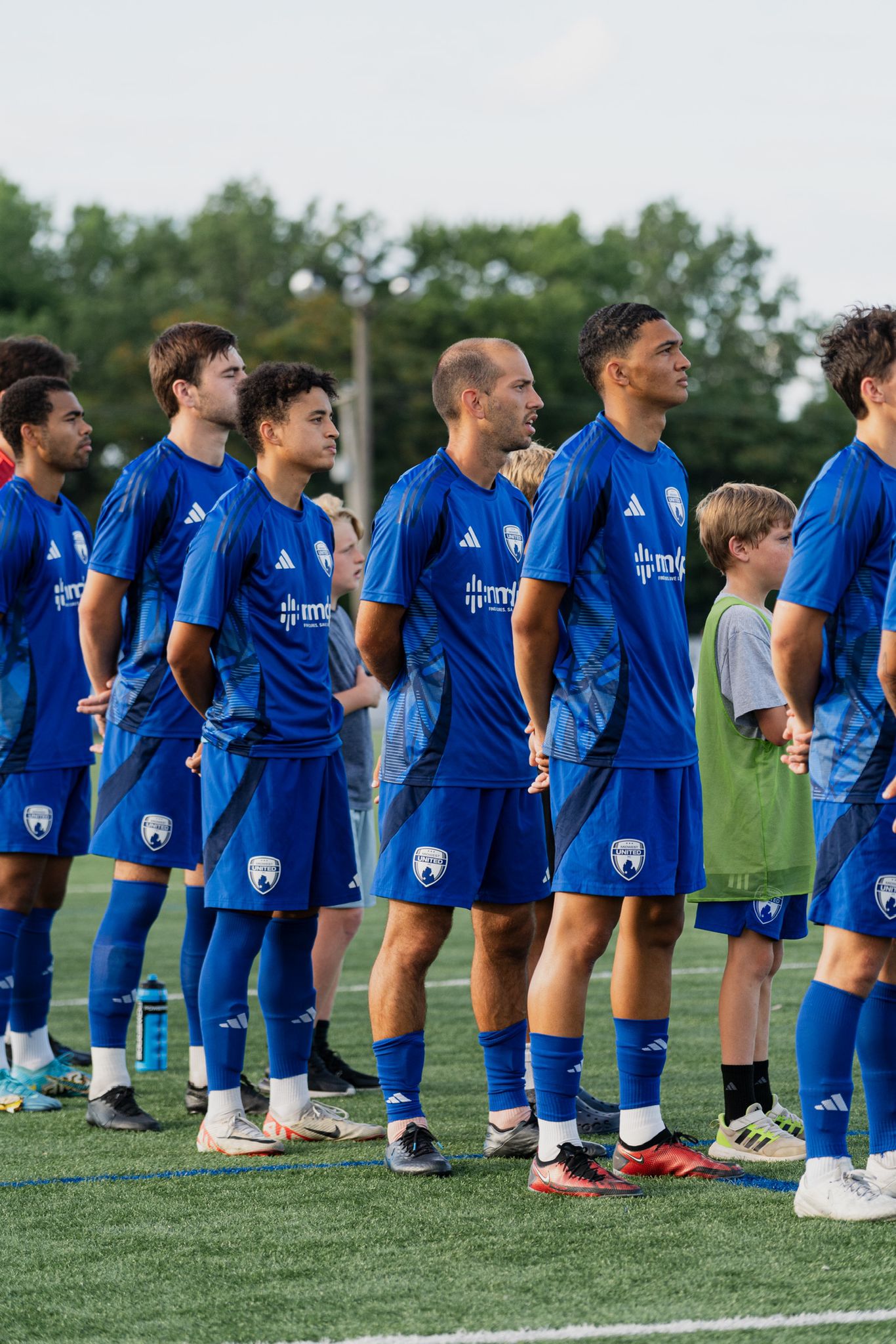 Team lined up on the pitch before kickoff — the moment of recognition