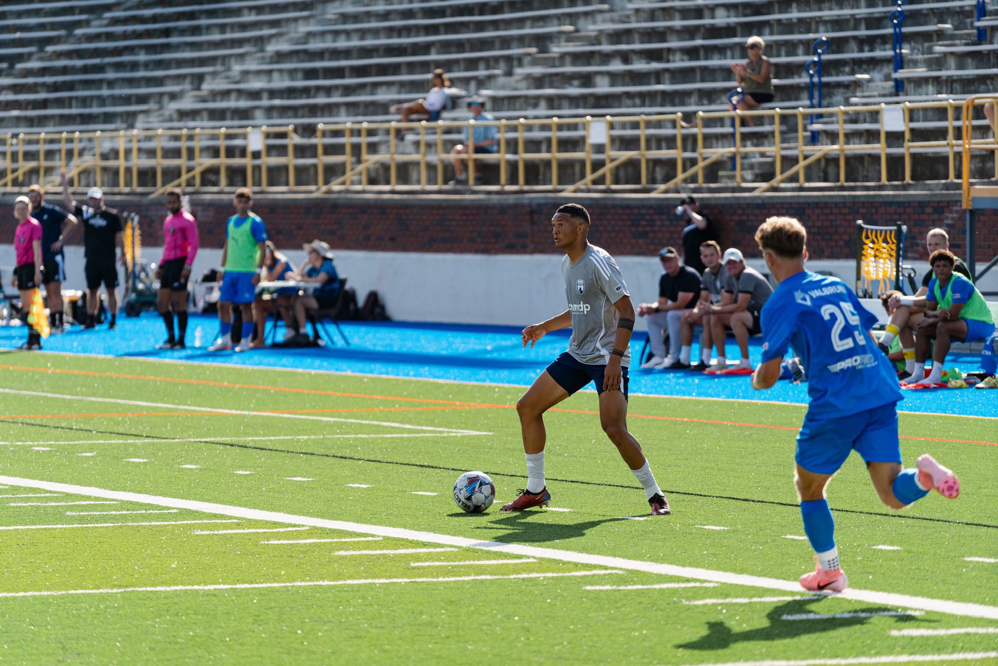 Match running inside a proper stadium structure with crowd in the stands