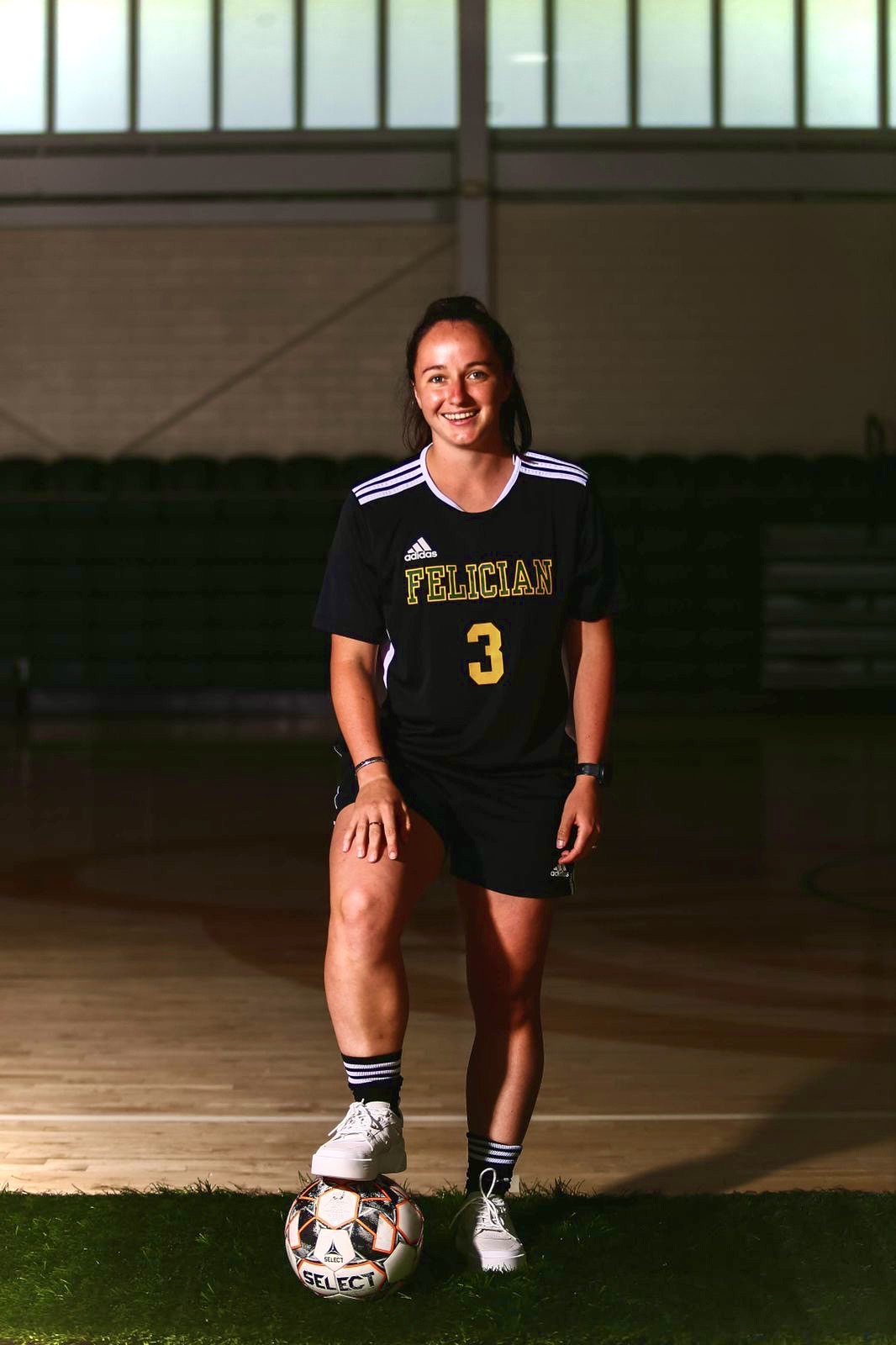 Signed athlete photographed in the Felician University kit